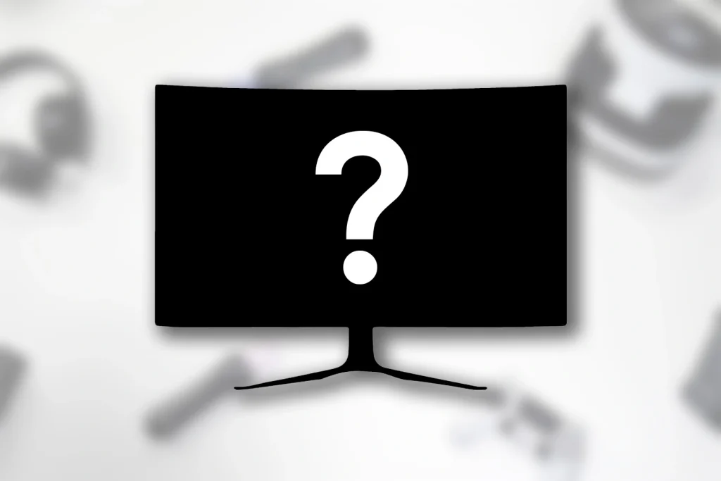 Billede af en ukendt sort skærm med hvidt spørgsmåltegn på en sløret hvid baggrund med en masse forskelligt gaming udstyr